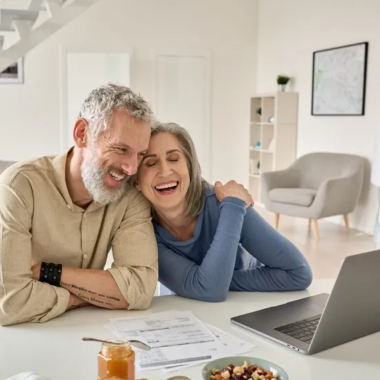 Happy,Mature,Older,Family,Couple,Laughing,,Bonding,Sitting,At,Home